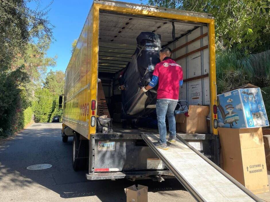 Movers loading a dedicated Thunderhorse truck.