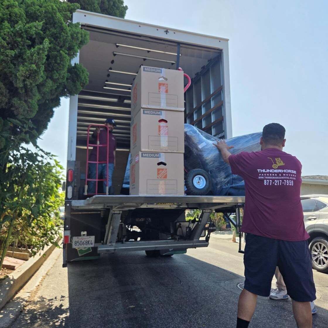 Movers loading a Thunderhorse truck.